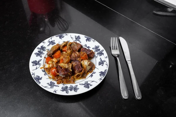 Homemade dish prepared of beef Ragout with vegetables. Homemade food concept.