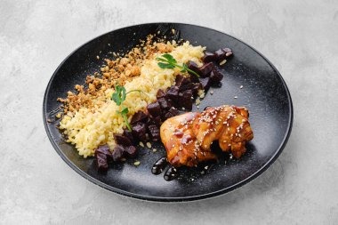 Teriyaki soslu kızarmış tavuk eti ve tabakta inci kabuğu.