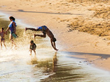 Salvador, Bahia, Brezilya - 05 Ocak 2019: Rio Vermelho 'daki Paciencia sahilinin sularında ve kumlarında koşan genç adam. Salvador Bahia Brezilya.