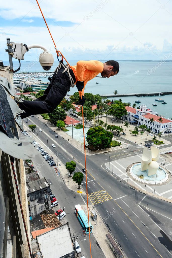 A man rappelling down the Lacerda Elevator. City of Salvador, Bahia, Brazil.