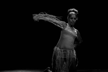 Çağdaş dansçı siyah arka plan ve saman aksesuarlarıyla tiyatroda dans ediyor. Salvador Bahia Brezilya.