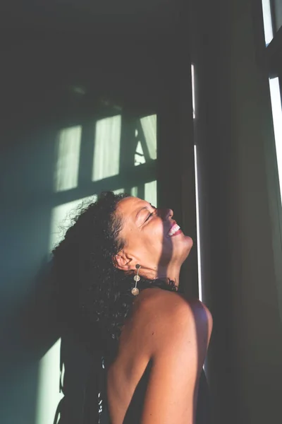 stock image Portrait of a woman against light and shadow background. Salvador, Bahia, Brazil.