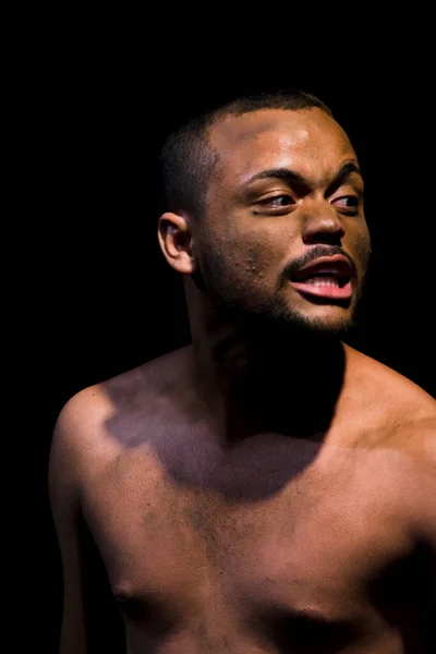 Actor on stage represents a dramatic character. Scene in a theater in the city of Salvador, Brazil.