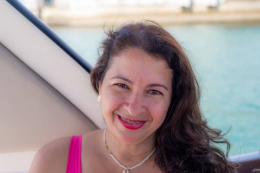 Portrait of a woman looking and smiling at the camera. Salvador, Bahia, Brazil.