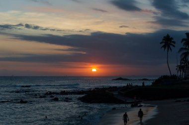 Salvador, Bahia, Brezilya 'da Ondina sahilinde dramatik turuncu gün batımı.