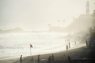 Salvador, Bahia, Brezilya - 26 Eylül 2021: Brezilya 'nın Bahia eyaletindeki Farol da Barra plajında insan grupları.