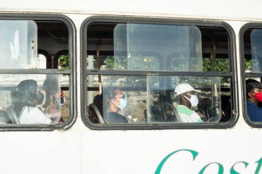 Salvador, Bahia, Brazil - November 01, 2021: People inside the bus wearing protective mask against covid-19 on the streets of Salvador, Bahia.