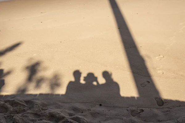 Human shadow on the beach sand. City of Salvador, Bahia, Brazil.