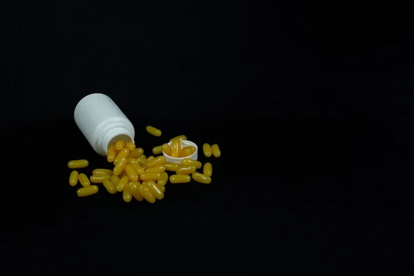 Some Yellow Fatty Acid Pills Isolated Black Background — Foto Stock