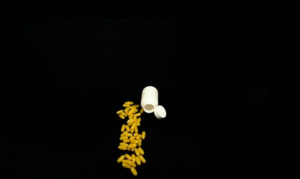 Some Yellow Fatty Acid Pills Isolated Black Background — Fotografia de Stock