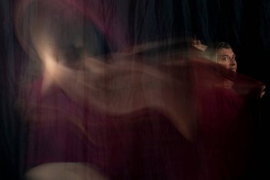 Time lapse view of woman moving a rag. Long exposure, motion blur. Salvador, Bahia, Brazil.