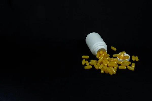 Some Yellow Fatty Acid Pills Isolated Black Background — Foto Stock