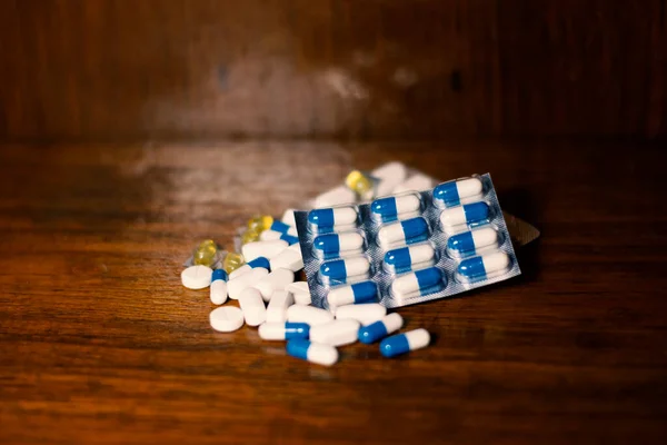 Simple Pile White Blue Yellow Pills Medicines Pills Stacked Brown — Zdjęcie stockowe