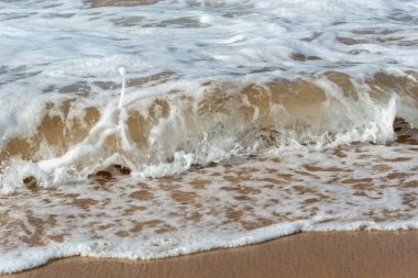 Low view of a beach against blue sky with clouds in the background. Barra beach lighthouse, Salvador, Brazil.