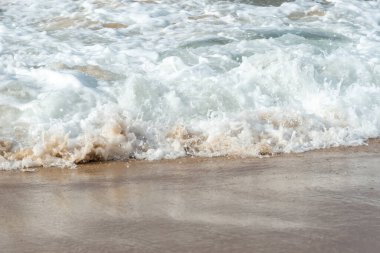 Low view of a beach against blue sky with clouds in the background. Barra beach lighthouse, Salvador, Brazil.
