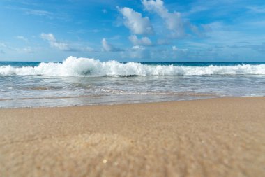 Low view of a beach against blue sky with clouds in the background. Barra beach lighthouse, Salvador, Brazil.