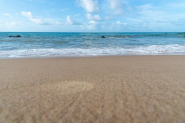 Low view of a beach against blue sky with clouds in the background. Barra beach lighthouse, Salvador, Brazil.