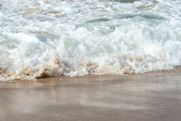 Low view of a beach against blue sky with clouds in the background. Barra beach lighthouse, Salvador, Brazil.