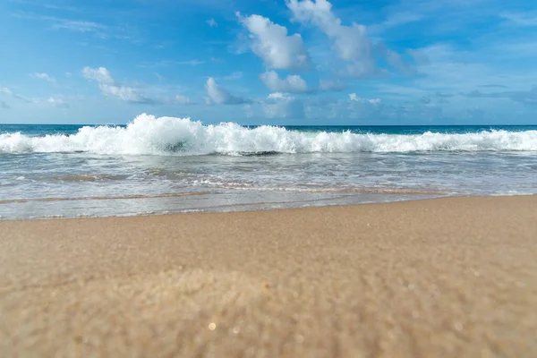 Low view of a beach against blue sky with clouds in the background. Barra beach lighthouse, Salvador, Brazil.