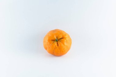 Surface covered with a ripe fresh juicy tangerine, composition isolated over the white background.