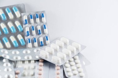 Carton of different pills, medicines, pills stacked on white background. Medical supplies.