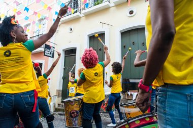Salvador, Bahia, Brazil - June 22, 2018: Dida Band members play percussion instruments at Pelourinho in Salvador, before the match between Brazil vs Costa Rica for the 2018 soccer world cup in Russia.