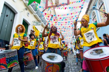 Salvador, Bahia, Brazil - June 22, 2018: Dida Band members play percussion instruments at Pelourinho in Salvador, before the match between Brazil vs Costa Rica for the 2018 soccer world cup in Russia. clipart