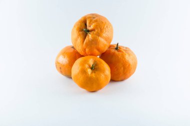 Surface covered with four ripe fresh juicy tangerines, composition isolated over the white background.