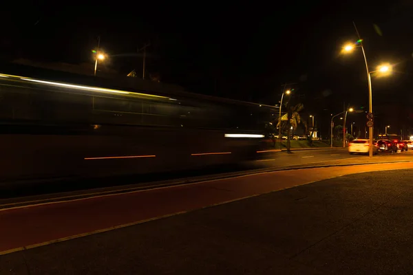 Colorful light trails with motion blur effect of a bus, long time exposure. Isolated in the foreground.