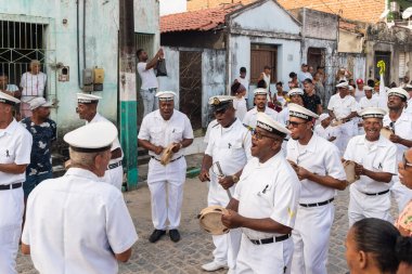 Saubara, Bahia, Brazil - August 06, 2022: Members of Marujada Fragata Brasileira parade and play percussion instrument at the Chegancas cultural meeting in Saubara, Bahia.