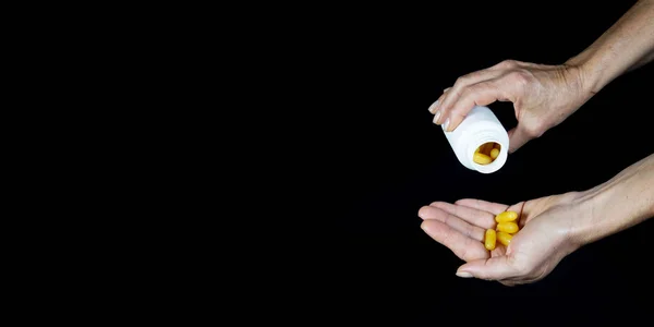 One Hand Pours Yellow Pills Palm Another Hand Black Background — Stockfoto
