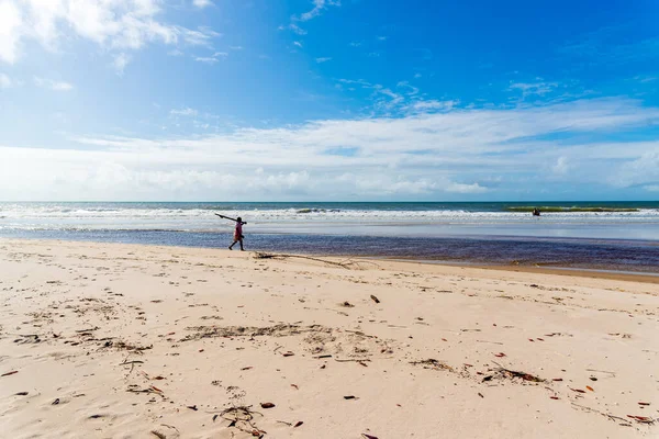 Fisherman is seen walking on the beach. Guaibim beach in the city of Valenca, Bahia, Brazil.