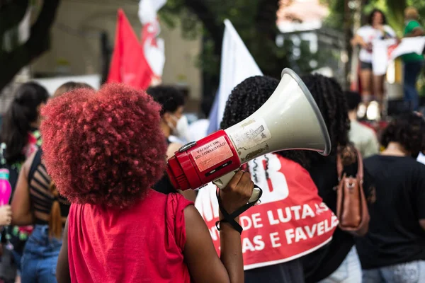 Salvador, Bahia, Brazil - April 09, 2022: Young people protesting against far-right presidential candidate Jair Bolsonaro, with megaphone posters and many screams.