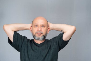 Portrait of mature man standing on white background. Serious bearded man. Formal style.