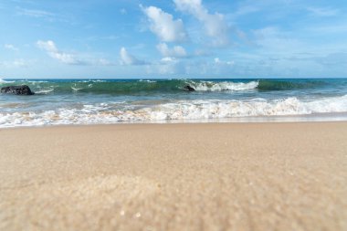 Low view of a beach against blue sky with clouds in the background. Barra beach lighthouse, Salvador, Brazil.
