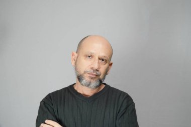 Portrait of mature man standing on white background. Serious bearded man. Formal style.
