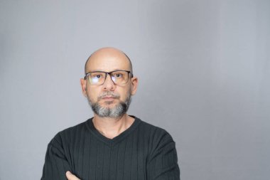 Portrait of mature man in prescription glasses, which is on white background. Serious bearded man. Formal style.