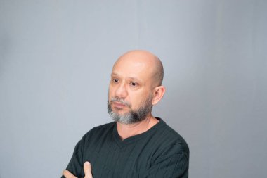 Portrait of mature man standing on white background. Serious bearded man. Formal style.