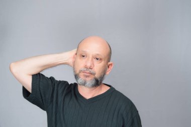 Portrait of mature man standing on white background. Serious bearded man. Formal style.