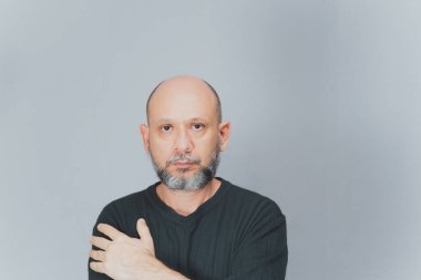 Portrait of mature man standing on white background. Serious bearded man. Formal style.