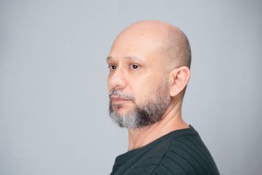 Portrait of mature man standing on white background. Serious bearded man. Formal style.