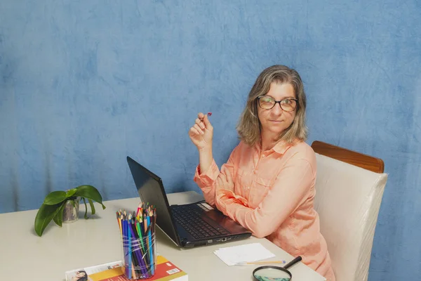 Thoughtful and worried woman with laptop computer working from home or office. Business, people and technology concept.