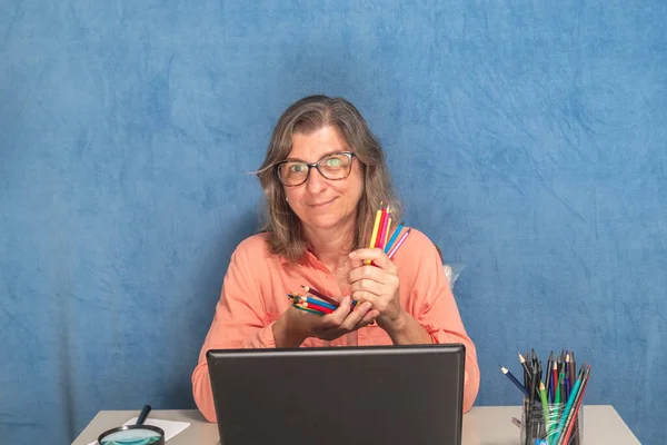 Happy woman with laptop computer working from home or office. Business, people and technology concept.