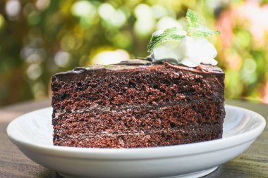 Closeup of chocolate cake in a plate on a wooden table