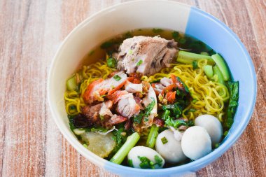 Clear soup noodles with pork and vegetables and fish balls and red pork