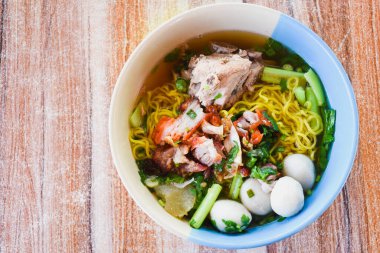 Clear soup noodles with pork and vegetables and fish balls and red pork
