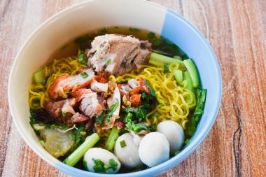 Clear soup noodles with pork and vegetables and fish balls and red pork