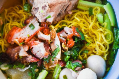 Clear soup noodles with pork and vegetables and fish balls and red pork