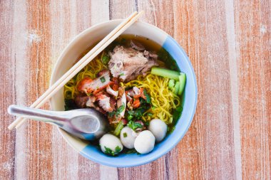 Clear soup noodles with pork and vegetables and fish balls and red pork