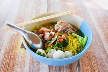 Clear soup noodles with pork and vegetables and fish balls and red pork